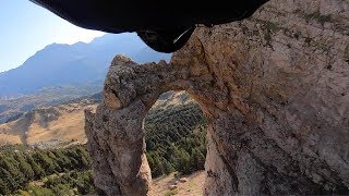 Wingsuit Pilot Flies Through Hole In Rock [upl. by Jacinto]